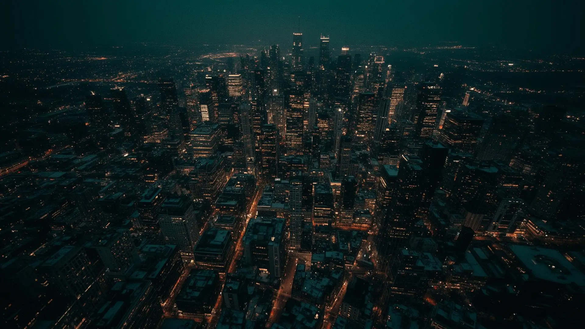 Aerial view of a city at night with illuminated streets and buildings